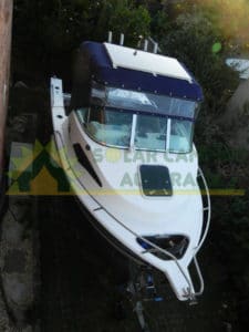 Photos of a 125W Solar Panel mounted on the boat along with a dual batttery solar controller charger.